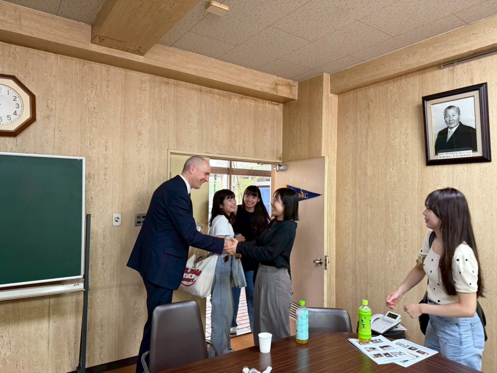 Group shaking hands and smiling