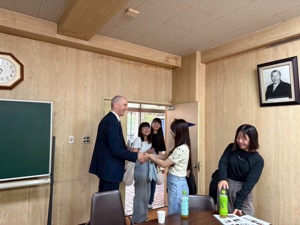 Group shaking hands and smiling