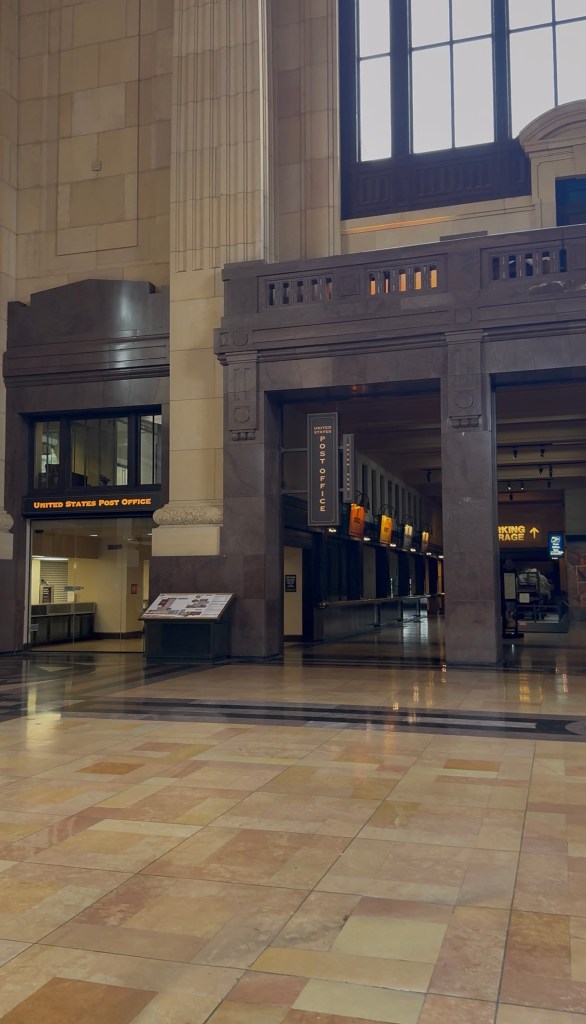 Signage reading "Post Office" in old train station.