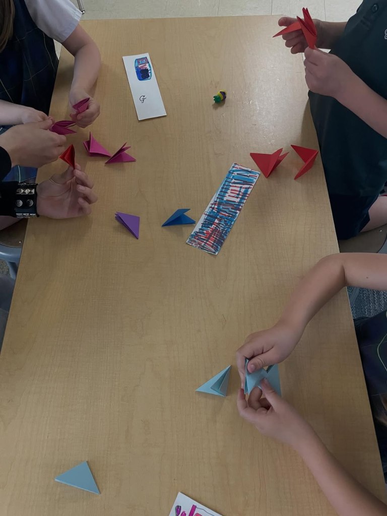 Kids folding a paper activity.