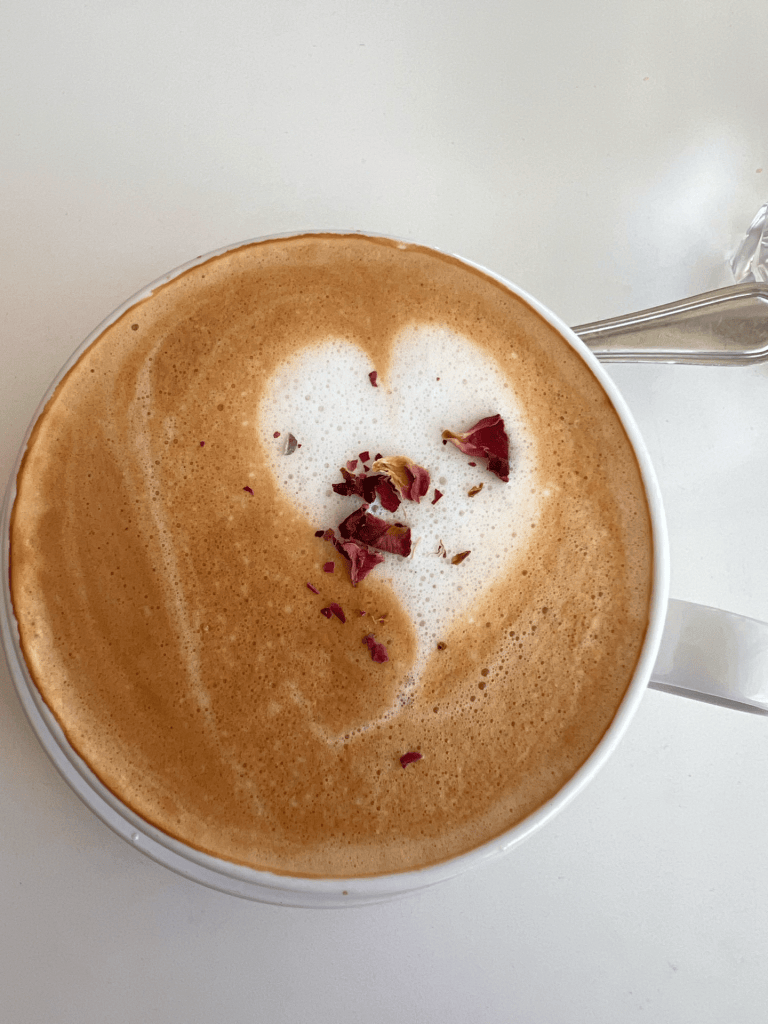 Image of a hot latte with a heart latte art.
