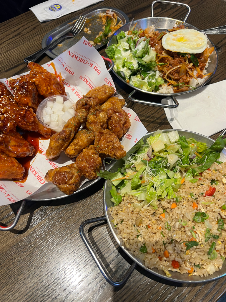 Chicken wings and fried rice on a table.