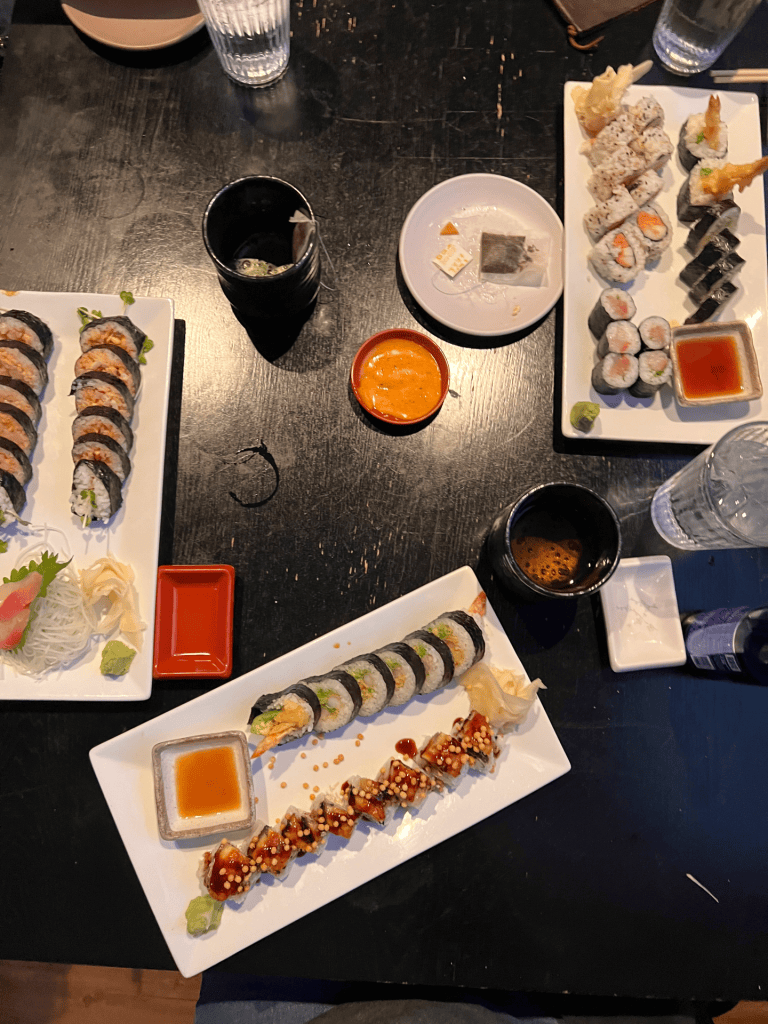 Image of sushi platters on a table.