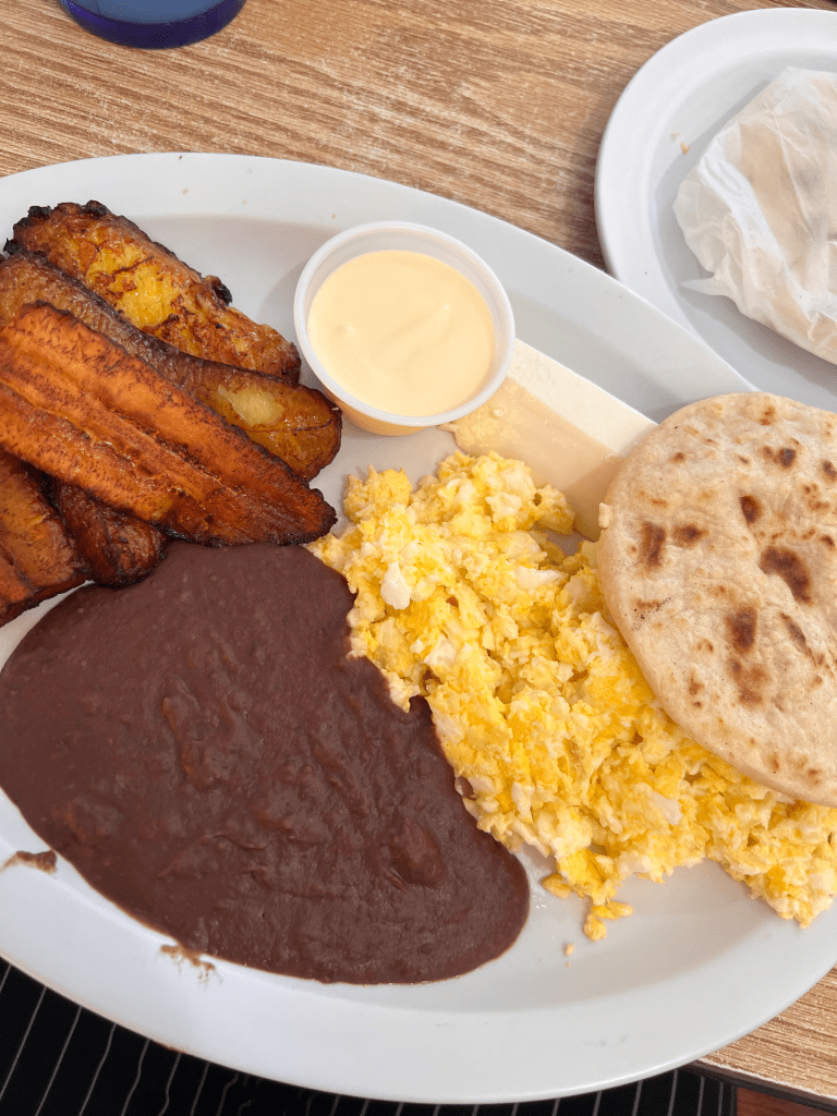 Plate featuring eggs, beans, tortillas and plantains.